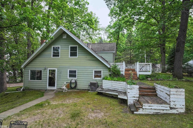 7199 Switzer Dr, Linden, MI 48451 - back of house featuring a yard, a wooden deck, and a chimney