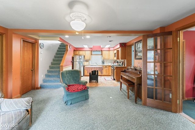7199 Switzer Dr, Linden, MI 48451 - living area featuring light colored carpet, stairway, and recessed lighting
