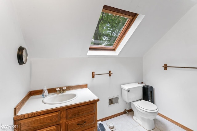 7199 Switzer Dr, Linden, MI 48451 - half bath featuring vaulted ceiling, vanity, a skylight, and tile patterned flooring