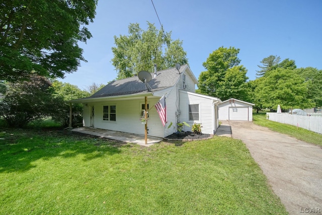 306 S Washington St, Manchester, MI 48158 - view of front of house featuring concrete driveway, an outdoor structure, and a detached garage