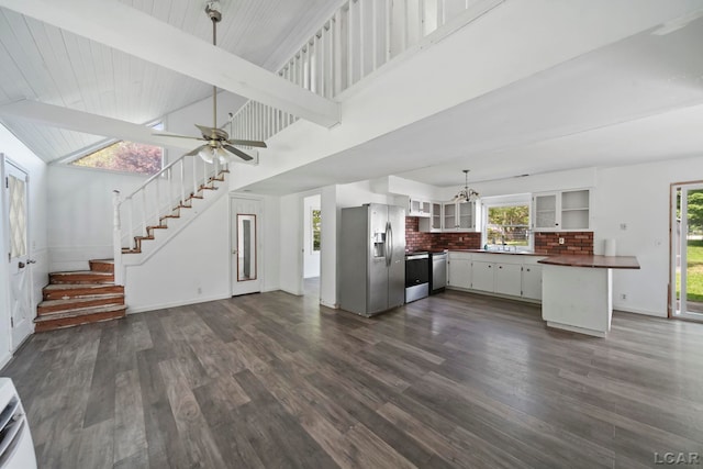 306 S Washington St, Manchester, MI 48158 - kitchen featuring stainless steel refrigerator with ice dispenser, dark countertops, a chandelier, dark wood-type flooring, and high vaulted ceiling
