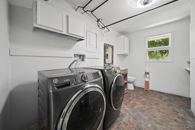 306 S Washington St, Manchester, MI 48158 - laundry room featuring washing machine and dryer and dark stone finish flooring