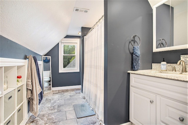325 Marshall St, Coldwater, MI 49036 - full bathroom with vaulted ceiling, vanity, and a textured ceiling