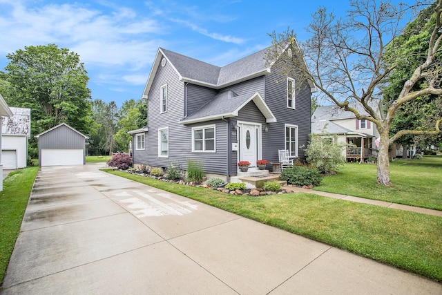 325 Marshall St, Coldwater, MI 49036 - view of front facade with a garage, a shingled roof, an outbuilding, and a front yard