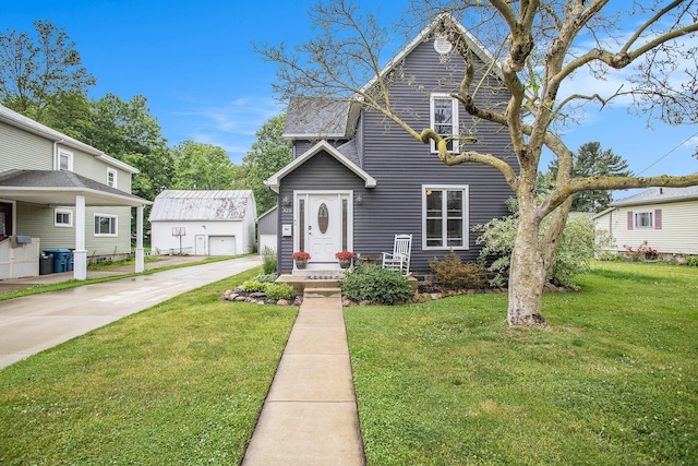 325 Marshall St, Coldwater, MI 49036 - traditional-style home featuring an outdoor structure, a front lawn, and driveway