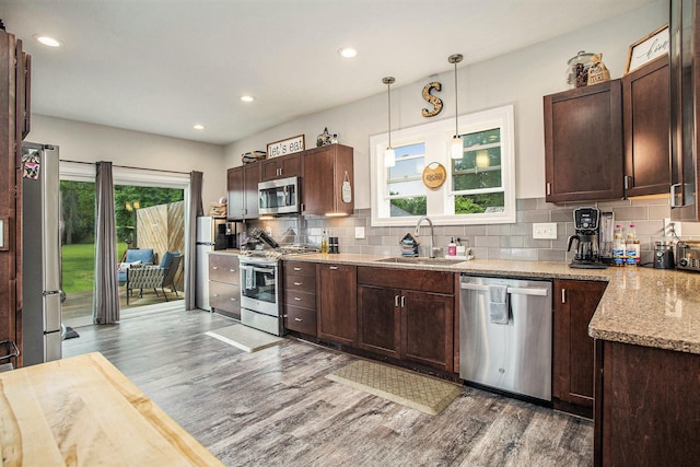 325 Marshall St, Coldwater, MI 49036 - kitchen with appliances with stainless steel finishes, wood finished floors, dark brown cabinetry, decorative backsplash, and recessed lighting