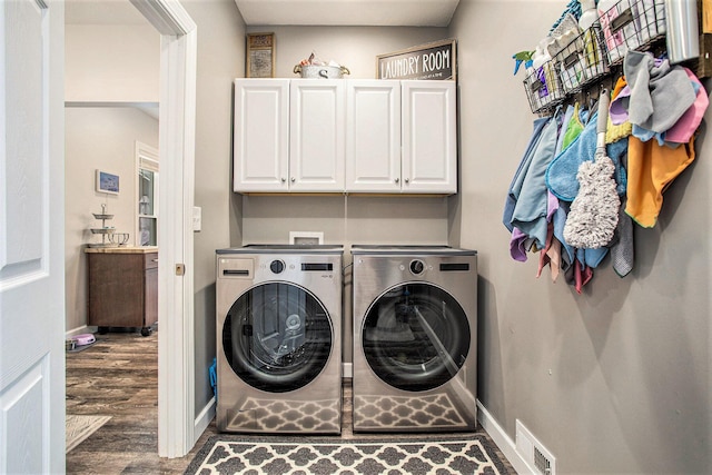 325 Marshall St, Coldwater, MI 49036 - laundry room with washer and clothes dryer, wood finished floors, and cabinet space