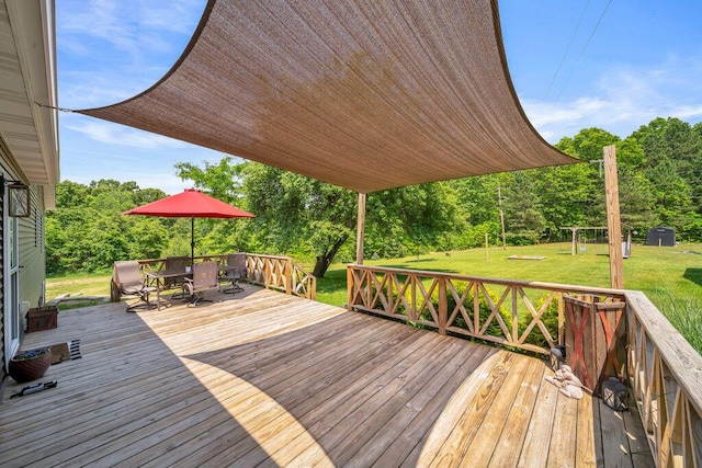 54727 Twin Lakes Rd, Dowagiac, MI 49047 - wooden terrace with outdoor dining area, a yard, and view of wooded area