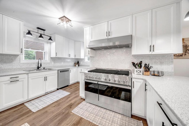54727 Twin Lakes Rd, Dowagiac, MI 49047 - kitchen featuring appliances with stainless steel finishes, under cabinet range hood, white cabinets, and light wood-style floors