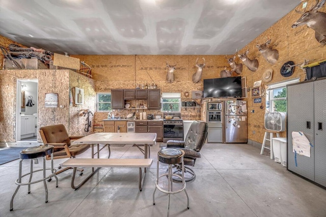 54727 Twin Lakes Rd, Dowagiac, MI 49047 - kitchen featuring concrete floors, freestanding refrigerator, plenty of natural light, and stainless steel range