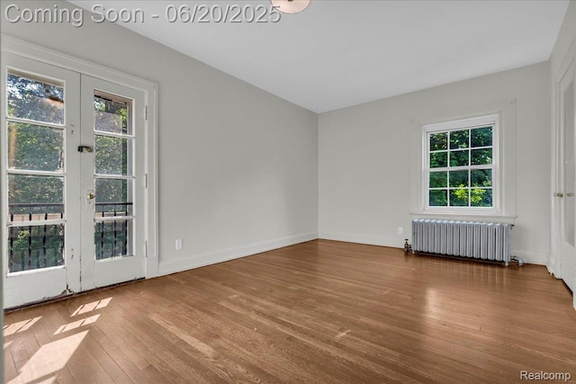 1710 Seminole St, Detroit, MI 48214 - empty room featuring radiator heating unit, wood finished floors, and french doors