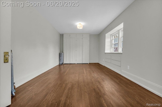 1710 Seminole St, Detroit, MI 48214 - unfurnished bedroom featuring radiator heating unit and wood finished floors