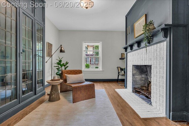 1710 Seminole St, Detroit, MI 48214 - living room with wood finished floors and a brick fireplace