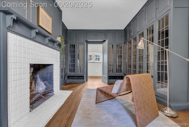 1710 Seminole St, Detroit, MI 48214 - sitting room with light wood-style floors and a brick fireplace
