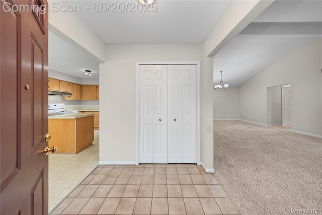 5805 Dawn Ridge Dr, Troy, MI 48098 - kitchen with white range with electric cooktop, under cabinet range hood, light countertops, a chandelier, and open floor plan