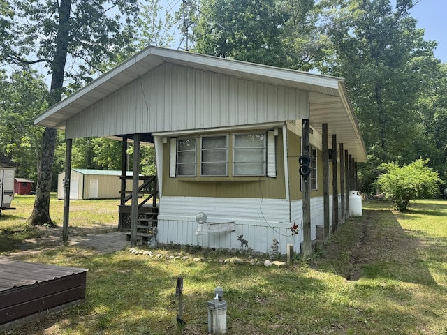 5859 N Utter Rd, Irons, MI 49644 - view of side of property featuring a lawn and a storage shed