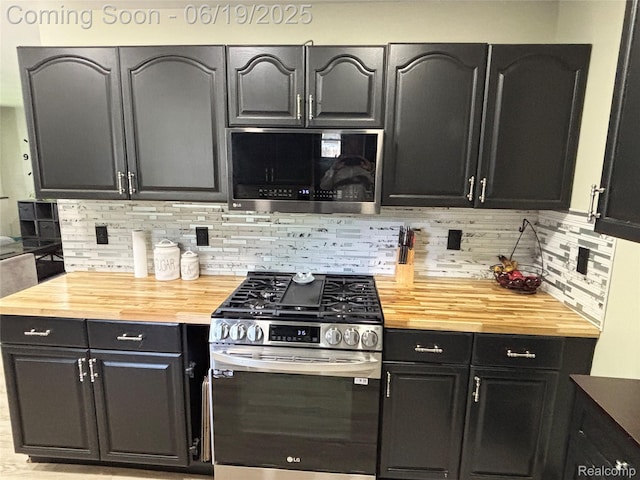 1745 Wisconsin Ave, Marysville, MI 48040 - kitchen featuring appliances with stainless steel finishes, wood counters, backsplash, and dark cabinetry