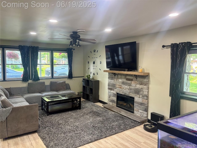 1745 Wisconsin Ave, Marysville, MI 48040 - living room featuring wood finished floors, plenty of natural light, a ceiling fan, a stone fireplace, and recessed lighting