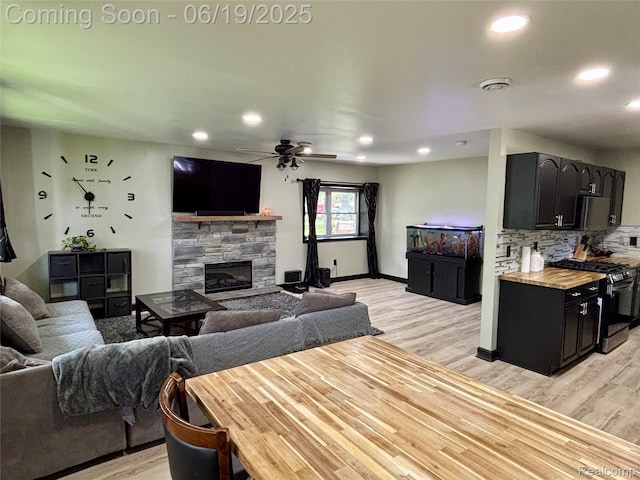 1745 Wisconsin Ave, Marysville, MI 48040 - living room with a stone fireplace, light wood-style floors, a ceiling fan, and recessed lighting