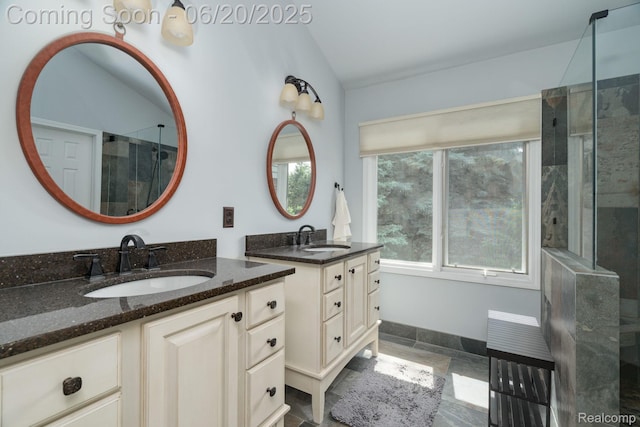4096 Villager Dr, Lake Orion, MI 48359 - bathroom with two vanities, a tile shower, and lofted ceiling
