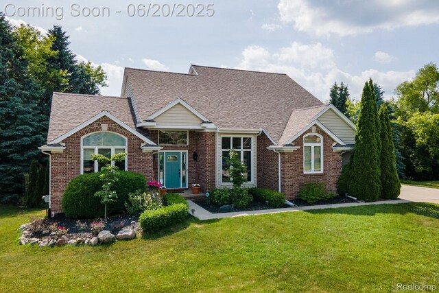 4096 Villager Dr, Lake Orion, MI 48359 - view of front of home featuring a front lawn, brick siding, and roof with shingles