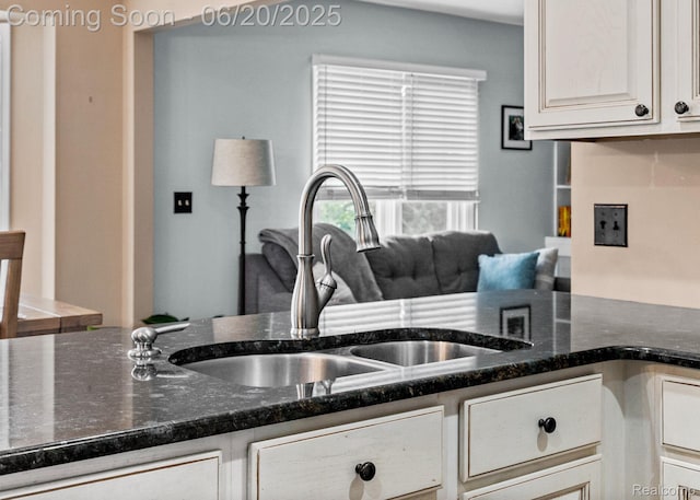 4096 Villager Dr, Lake Orion, MI 48359 - kitchen with dark stone countertops and white cabinets