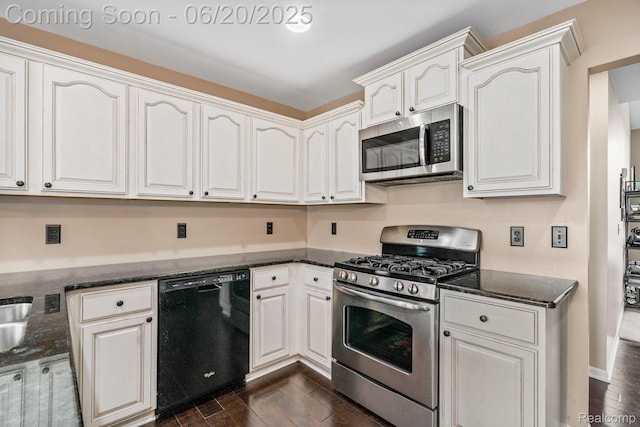 4096 Villager Dr, Lake Orion, MI 48359 - kitchen with appliances with stainless steel finishes, dark wood-style flooring, dark stone counters, and white cabinets