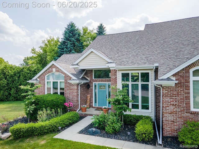 4096 Villager Dr, Lake Orion, MI 48359 - view of front of home featuring brick siding and a shingled roof