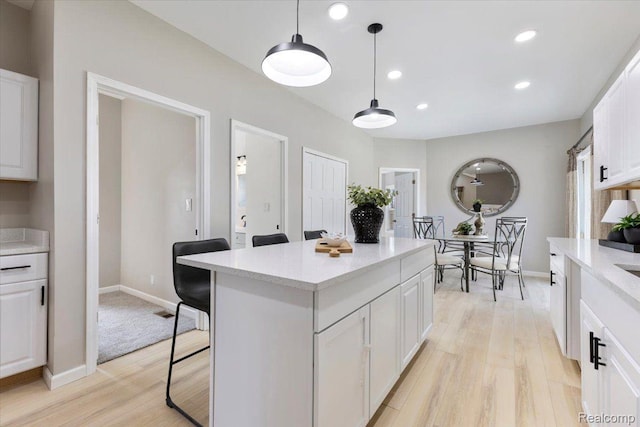 2553 Marlborough St, Detroit, MI 48215 - kitchen featuring light wood-style floors, light countertops, white cabinetry, recessed lighting, and a kitchen breakfast bar