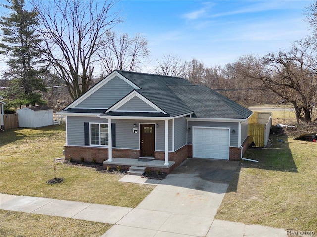 2553 Marlborough St, Detroit, MI 48215 - view of front of property with an attached garage, brick siding, driveway, and a porch