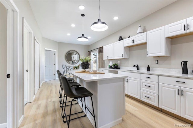 2553 Marlborough St, Detroit, MI 48215 - kitchen with light wood-type flooring, a center island, white cabinets, and recessed lighting