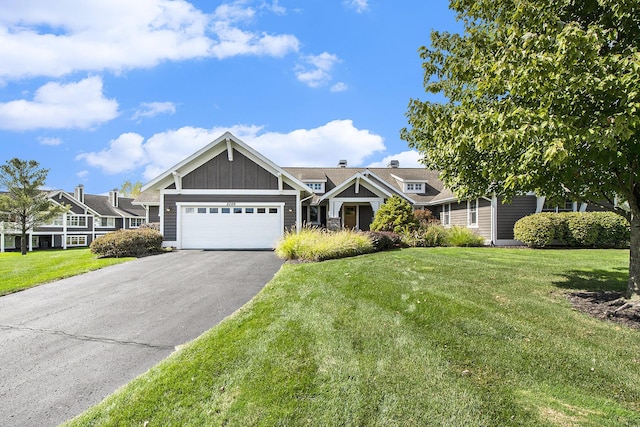 2069 Watermark Dr SE, Grand Rapids, MI 49546 - view of front of house with asphalt driveway, an attached garage, a front lawn, and board and batten siding
