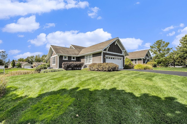 2069 Watermark Dr SE, Grand Rapids, MI 49546 - view of front of home with an attached garage, driveway, a front lawn, and board and batten siding