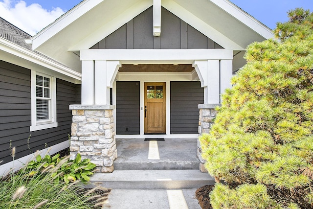 2069 Watermark Dr SE, Grand Rapids, MI 49546 - view of exterior entry featuring board and batten siding and covered porch
