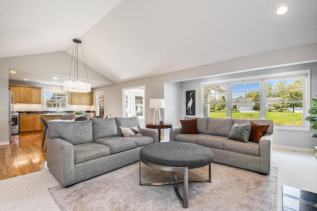 2069 Watermark Dr SE, Grand Rapids, MI 49546 - living room featuring lofted ceiling, recessed lighting, and light wood-type flooring