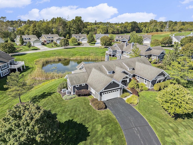 2069 Watermark Dr SE, Grand Rapids, MI 49546 - aerial view of residential area featuring a nearby body of water and a tree filled landscape
