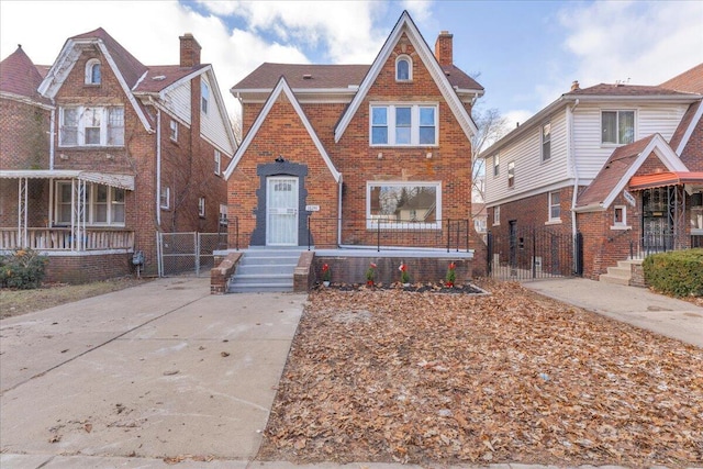 16241 Cherrylawn St, Detroit, MI 48221 - tudor-style house with a gate, brick siding, and a chimney