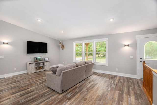 8577 Loveless Dr, Howard City, MI 49329 - living area with dark wood-style floors, vaulted ceiling, and recessed lighting