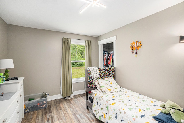 8577 Loveless Dr, Howard City, MI 49329 - bedroom featuring wood finished floors and baseboards