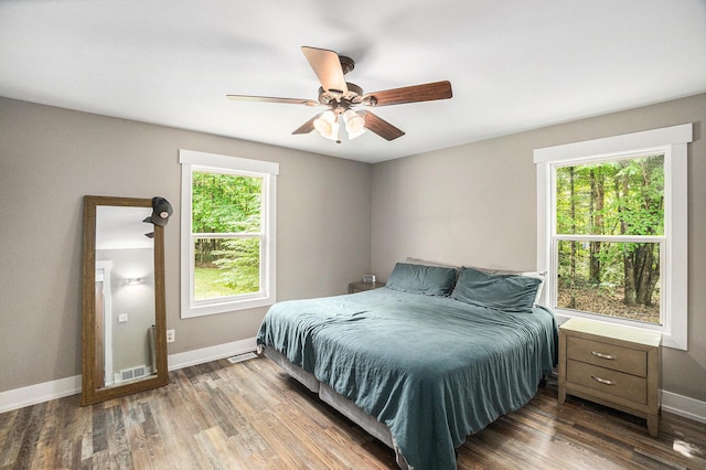 8577 Loveless Dr, Howard City, MI 49329 - bedroom with multiple windows, wood finished floors, and a ceiling fan