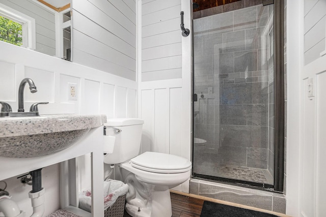 8577 Loveless Dr, Howard City, MI 49329 - full bathroom featuring a shower stall, a decorative wall, wood finished floors, and vanity