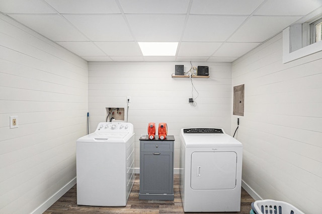 8577 Loveless Dr, Howard City, MI 49329 - laundry area featuring washing machine and dryer, dark wood-type flooring, wooden walls, and electric panel