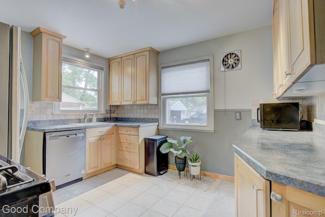 1012 W 12 Mile Rd, Royal Oak, MI 48073 - kitchen with stainless steel dishwasher, light brown cabinets, fridge, and backsplash