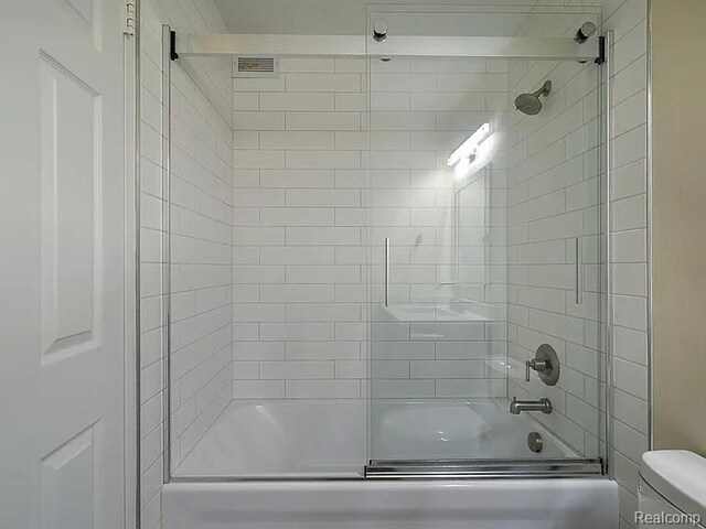 1050 Wall St Unit 2E, Ann Arbor, MI 48105 - bathroom with toilet and combined bath / shower with glass door