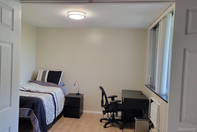 1050 Wall St Unit 2E, Ann Arbor, MI 48105 - bedroom with light wood-style flooring and a desk