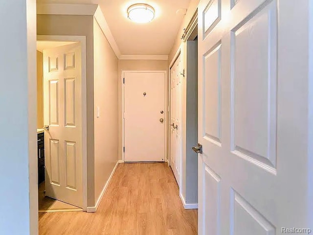 1050 Wall St Unit 2E, Ann Arbor, MI 48105 - hallway featuring light wood finished floors and crown molding
