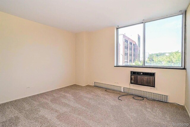 1050 Wall St Unit 2E, Ann Arbor, MI 48105 - empty room with carpet, a baseboard radiator, and a wall mounted AC