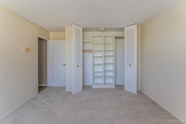 1050 Wall St Unit 2E, Ann Arbor, MI 48105 - unfurnished bedroom featuring carpet flooring and a closet