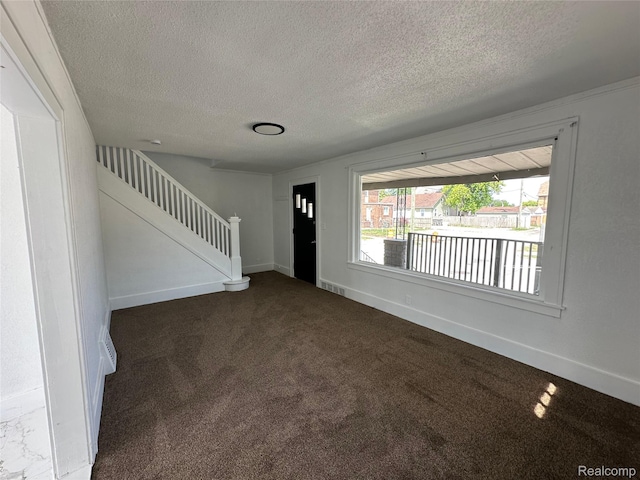 4222 High St, Ecorse, MI 48229 - empty room featuring a textured ceiling, stairway, and dark colored carpet