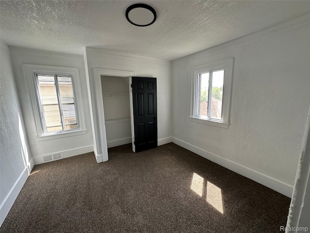 4222 High St, Ecorse, MI 48229 - unfurnished bedroom with a textured ceiling, multiple windows, dark colored carpet, a closet, and ornamental molding